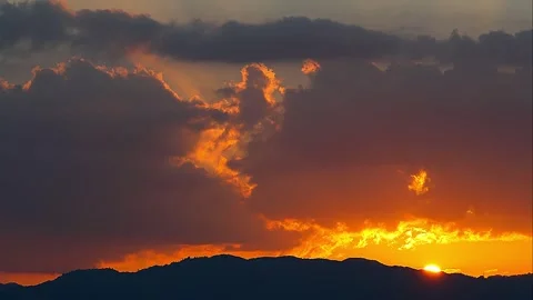 The exact moment sun sets while beautifully illuminating clouds Japan dusk, 02 Stock Footage 340537254