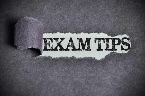 Exam tips word under torn black sugar paper Stock Photos