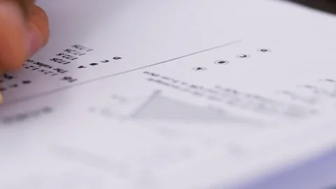 Examination, evaluations, tests: man's hand compile a test Stock Footage