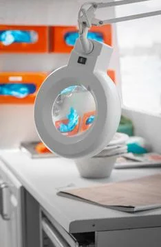 Examination laboratory setting featuring a magnifying lamp and PPE Fotos de archivo