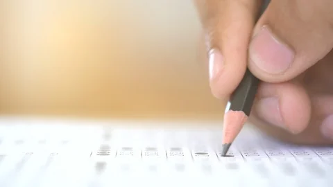 Examination test concept, close up pencil on test answer paper, pencil on hand Vidéo 96049110