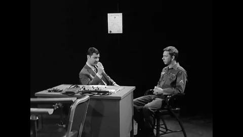 An Examiner attaches a subject to a polygraph machine for a test as a Chief Stock Footage 79524352