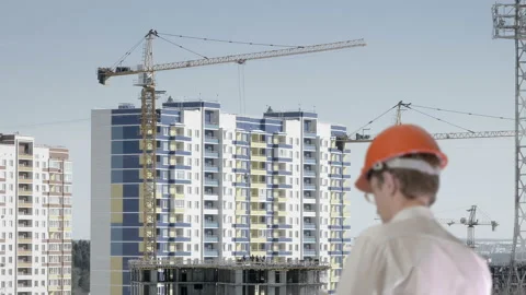The examiner monitors the progress of the construction of the apartment building Stock Footage 88063283