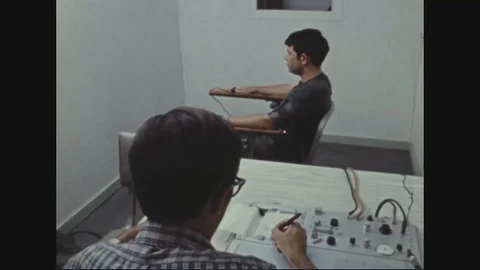 Examiner work controls of polygraph machine and make notations - 1972 Stock Footage 97906558
