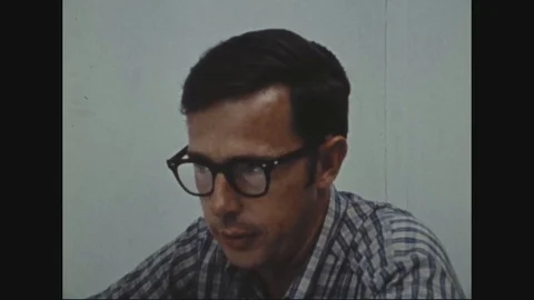 Examiner work controls of polygraph machine and make notations - 1972 Stock Footage 97906568