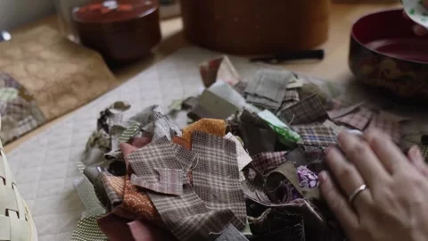 Examining and sorting small fabric scraps for a craft project Stock Footage 315084829