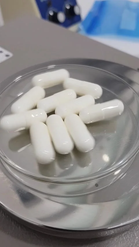 Examining and weighing capsules on a precision balance. Stock Footage 239143818