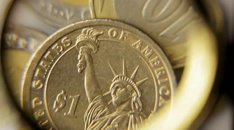 Examining a coin one dollar Stock Footage 10919585