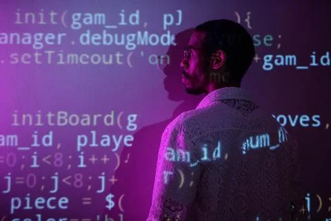 Examining Computer Code Projected on Wall Foto stock