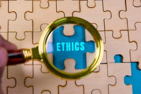 Examining ethics as a puzzle piece Stock Photos