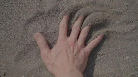 Examining the Handprint Embedded in Sandy Ground under Natural Light during Stock Footage 280327394