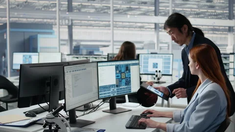 Examining microchip circuit layouts, computer and senior manager with woman Stock Footage 335879233