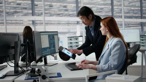Examining microchip circuit layouts, computer and senior manager with woman Stock Footage 335881077