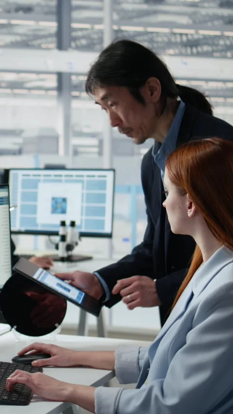 Examining microchip circuit layouts, computer and senior manager with woman Stock Footage 335882999