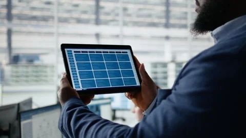 Examining microchip circuit layouts, tablet close up and engineer in factory Stock Footage 335880610