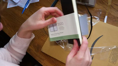 Examining Moleskine 2020 Planner Features Post-Unboxing Stock Footage 303868119