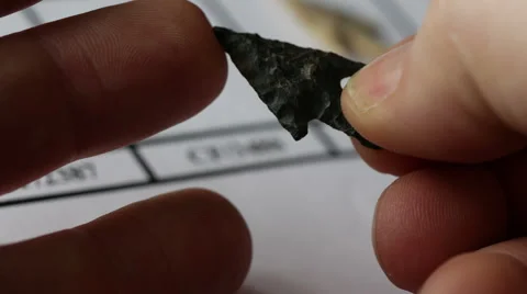Examining neolithic flint arrowheads in hands, 4k, UHD Stock Footage 48784803