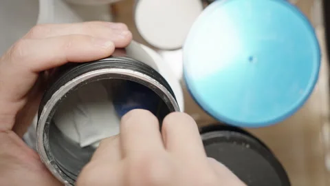 Examining pre-workout powder, observing a cloud of fine particles surrounding Stock Footage 283785293