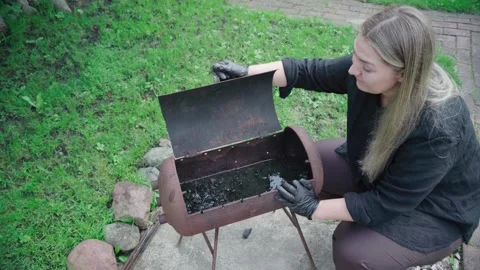Examining Rusted Handmade Backyard BBQ Grill Full of Standing Water Stock Footage 340116121