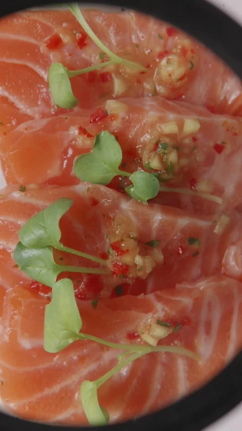 Examining salmon sashimi quality close up through a magnifying glass Stock Footage 335143661