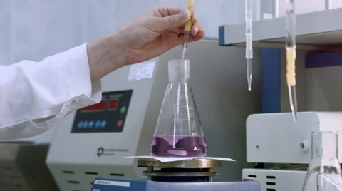 Examining sample and mix liquid in flask Stock-Footage 52030033