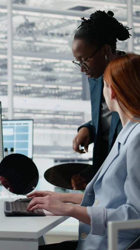 Examining semiconductor substrate, working together and women in office Stock Footage 335883024