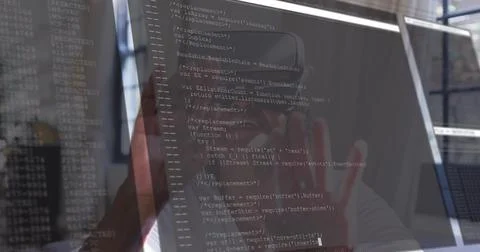 Examining senior woman reading code on work monitor with glossy screen and Foto stock