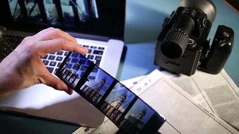 Examining shoot on computer and medium format color reversal film. Video stock 85911518