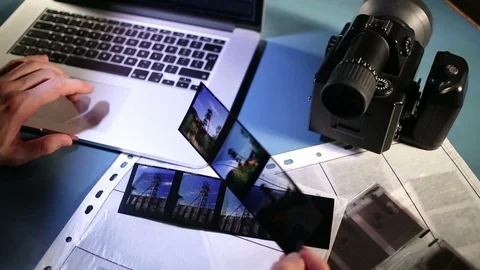 Examining shoot on computer and medium format color reversal film. Stock Footage 85912671