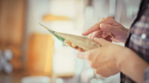 Examining soft plastic packaging a girl in the kitchen reads the product com Stock Footage 338187003