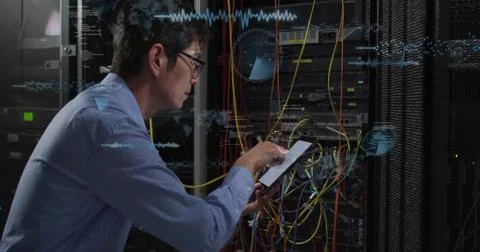 Examining wiring, IT technician using tablet in data center, network racks, Stock Photos