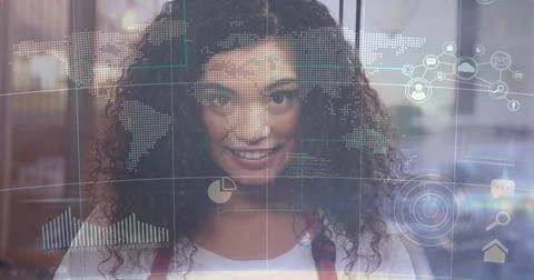 Examining world map and chart overlays through clear glass panel by Hispanic Stock Photos