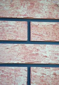 An example of a facing panel imitating brickwork in beige and peach colours Stock Photos