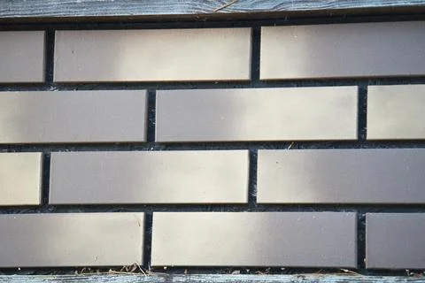 An example of a facing panel imitating brickwork in shades of grey Stock Photos