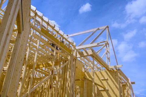 An example of framing beams at wooden framework of a new house under Stock Photos