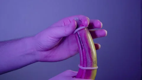 An example of the incorrect use of two condoms can be seen on a ripe yellow Stock-Footage 308399095