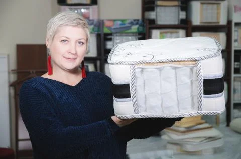 An example sampler is the material of a mattress in the hands of an attractive Stock Photos