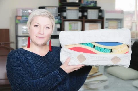An example sampler is the material of a mattress in the hands of an attractive Stock Photos