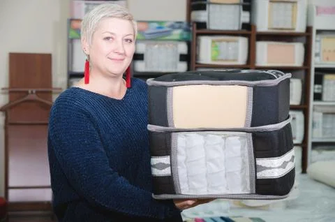 An example sampler is the material of a mattress in the hands of an attractive Stock Photos