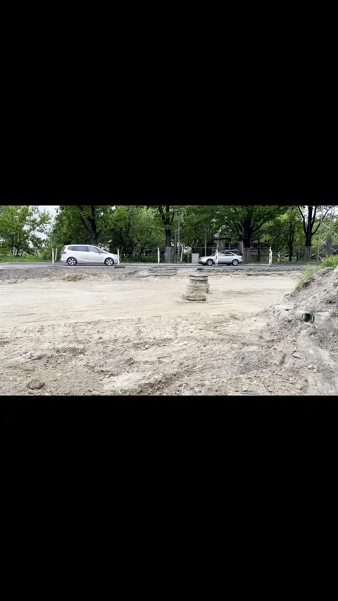 Excavated Road Construction Site with Passing City Traffic Stock Footage 341569183