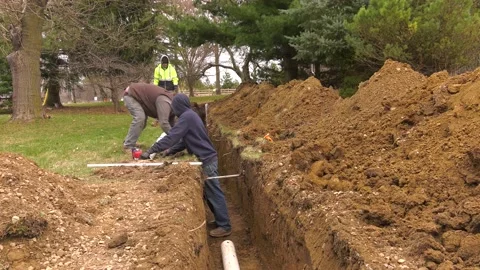 Excavating crew installs pipe underground 01610046 Video stock 153242925