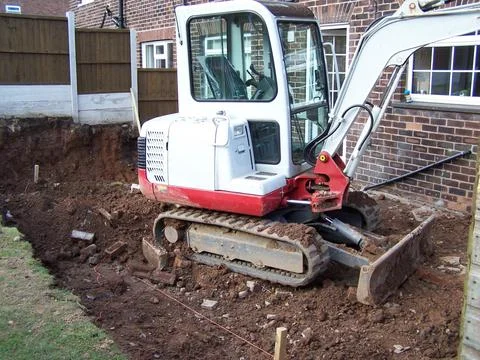 Excavating ground for a domestic extension, home office build concept Stock Photos
