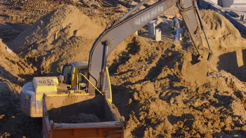 Excavation at a construction site, excavator loads the truck with earth  Stock Footage 147632817