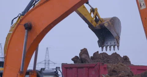 Excavation at a construction site, excavators loads the trucks with earth  Stock Footage 147602803