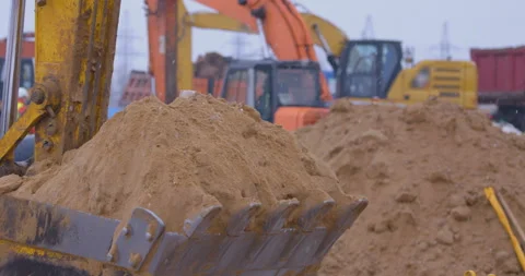 Excavation at a construction site, excavators loads the trucks with earth  Stock Footage 147604687