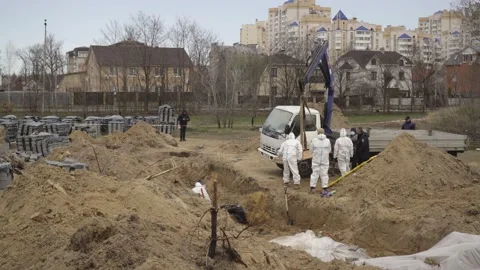 The excavation of a mass grave in Bucha Stock Footage 183958588