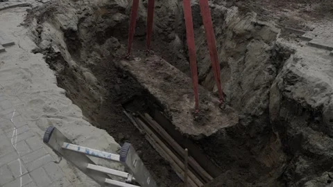 Excavation process with construction support beams and worker activity Stock Footage 316998780
