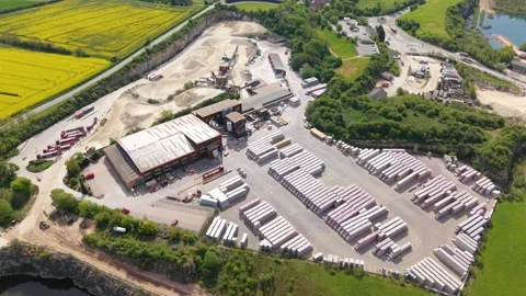 Excavation quarry pit leading to brick manufacturing kilns, forward drone Stock Footage 346653330