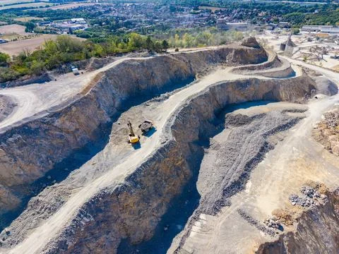 Excavation site functioning in a quarry with machinery working on a clear day Stock Photos