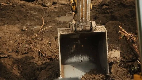 Excavation work at a construction site. Excavator bucket lifts the ground Video stock 126324686